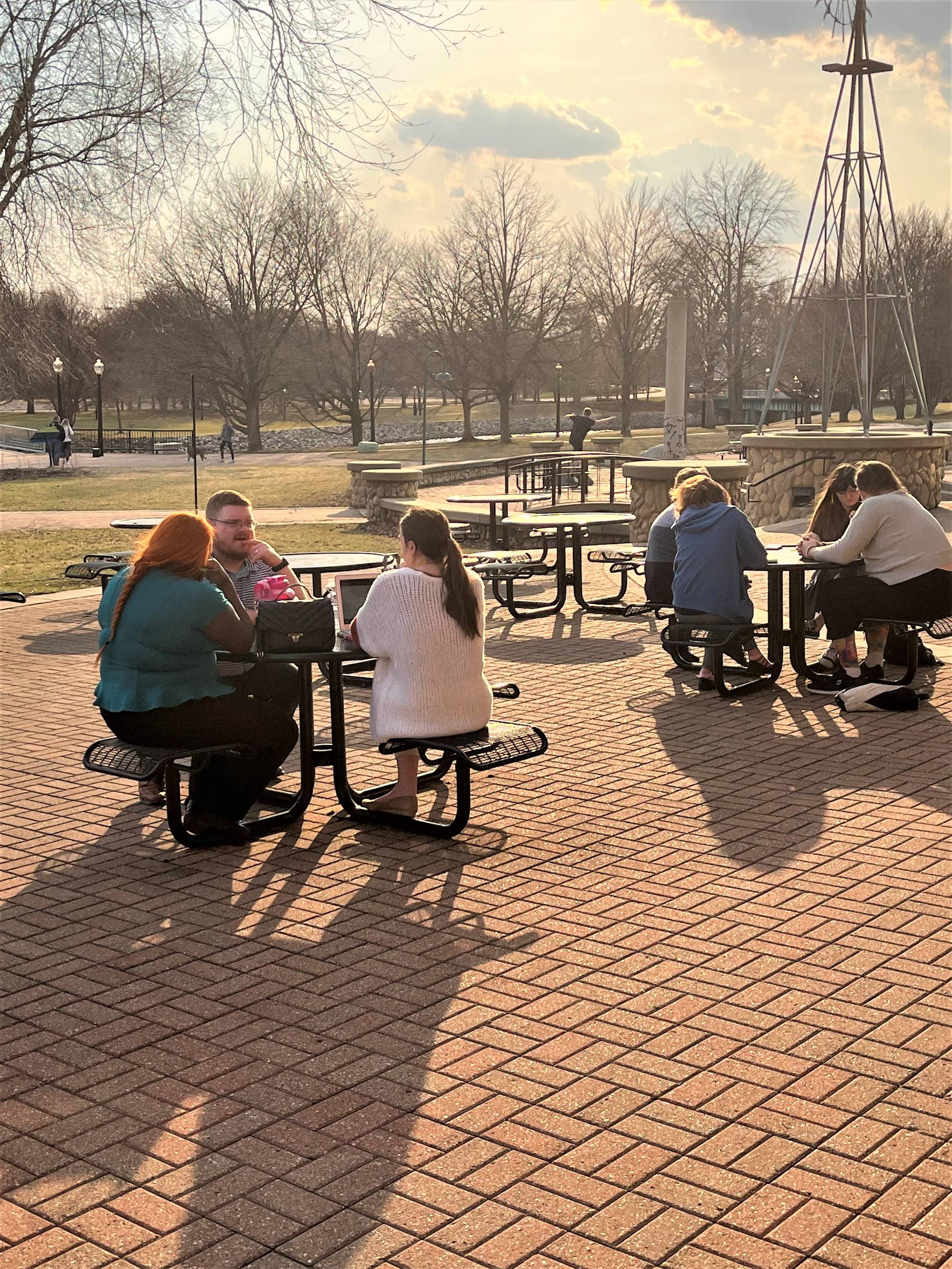 Early career teachers at tables outside